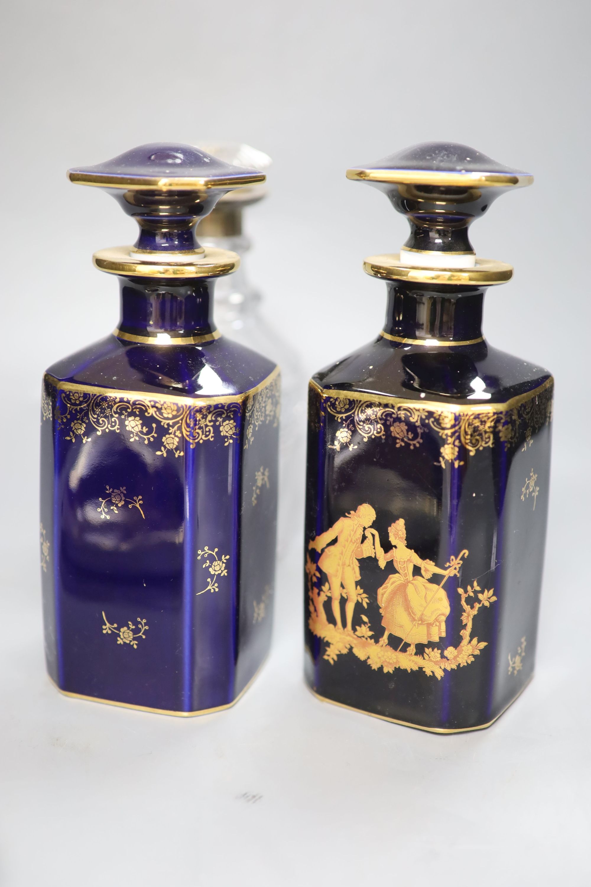 A pair of Limoges scent flasks, a silver mounted glass decanter and a Coalport dish, tallest 23cm